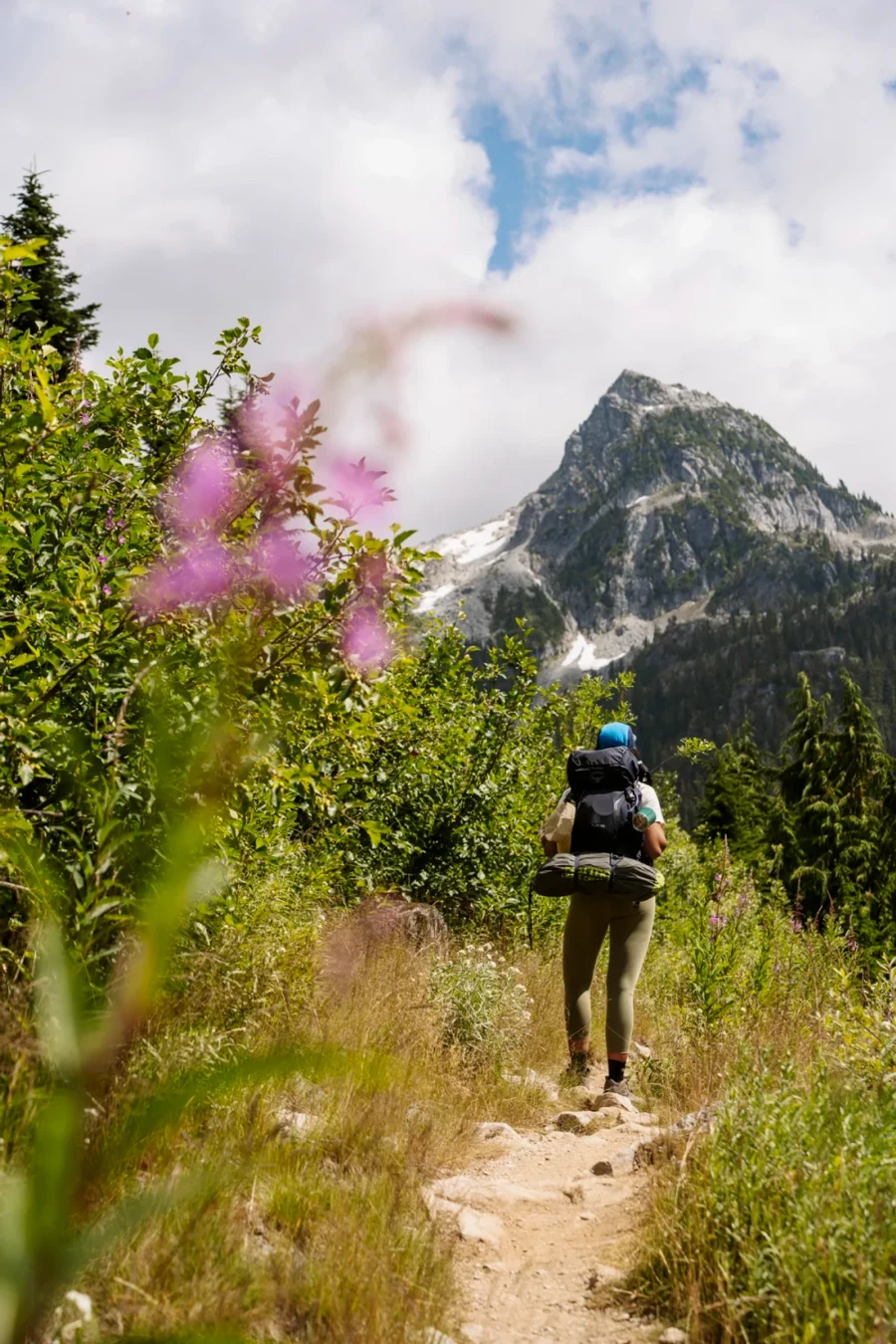 Woman with a large backpack hiking the  trail to Watersprite Lake