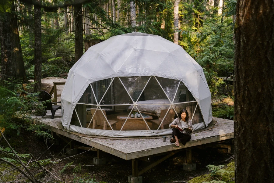 Where To Stay On The Sunshine Coast: Woman reads outside her glamping pod